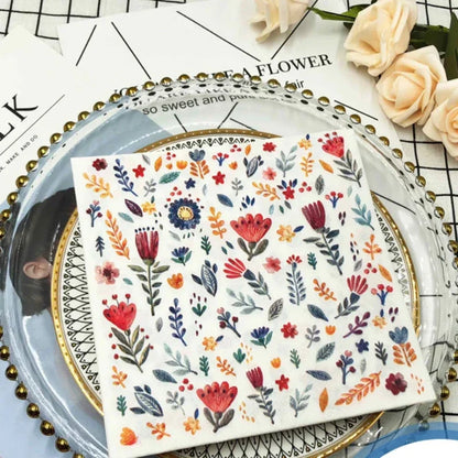 Colorful printed square paper napkins with floral design, suitable for restaurant, wedding, or hotel table settings.