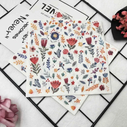 Colorful printed square paper napkins with floral design, ideal for restaurant, hotel, or wedding table settings.