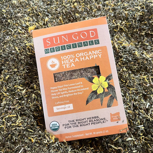 Heka Happy Organic Herbal Tea in a 2oz package with fresh herbs and leaves, showcasing the herbal blend in a clear bag.