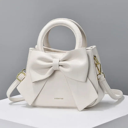 Fashion casual women's handbags with cute bows in black, white, blue, and khaki; trendy PU shoulder and underarm bags.