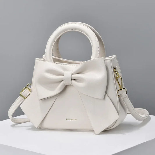 Fashion casual women's handbags with cute bows in black, white, blue, and khaki; trendy PU shoulder and underarm bags.
