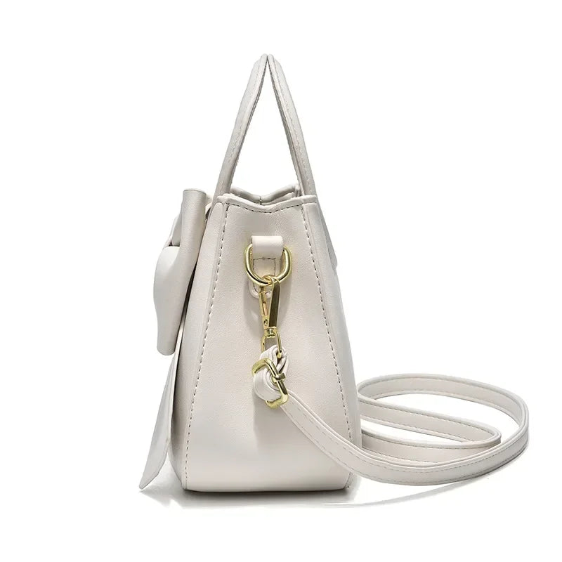 Fashion casual women's handbags with cute bow design in black, white, blue, and khaki PU material, daily shoulder and underarm bags.