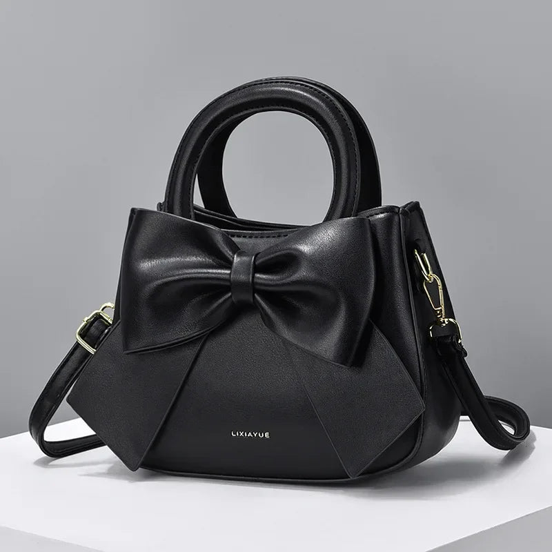 Fashion casual women's handbags with cute bow design in black, white, blue, and khaki PU material, featuring shoulder and underarm styles.