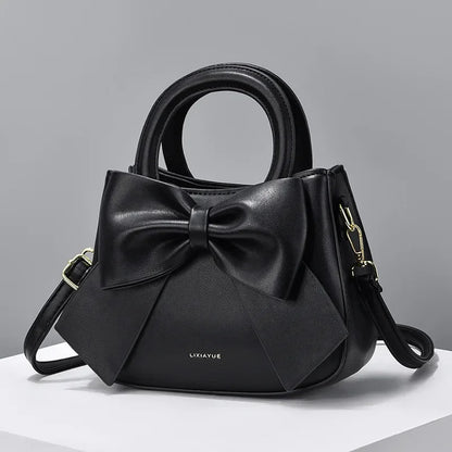 Fashion casual women's handbags with cute bow design in black, white, blue, and khaki PU material, featuring shoulder and underarm styles.