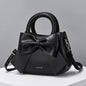 Fashion casual women's handbags with cute bow design in black, white, blue, and khaki PU material, featuring shoulder and underarm styles.