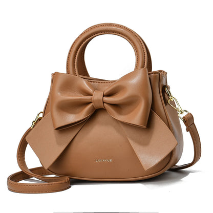 Fashion casual women’s handbags with cute bows in black, white, blue, and khaki, featuring PU material and shoulder strap design.