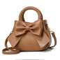 Fashion casual women’s handbags with cute bows in black, white, blue, and khaki, featuring PU material and shoulder strap design.