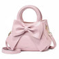 Fashion casual women's handbags with cute bows in black, white, blue, and khaki, featuring PU material and trendy shoulder designs.