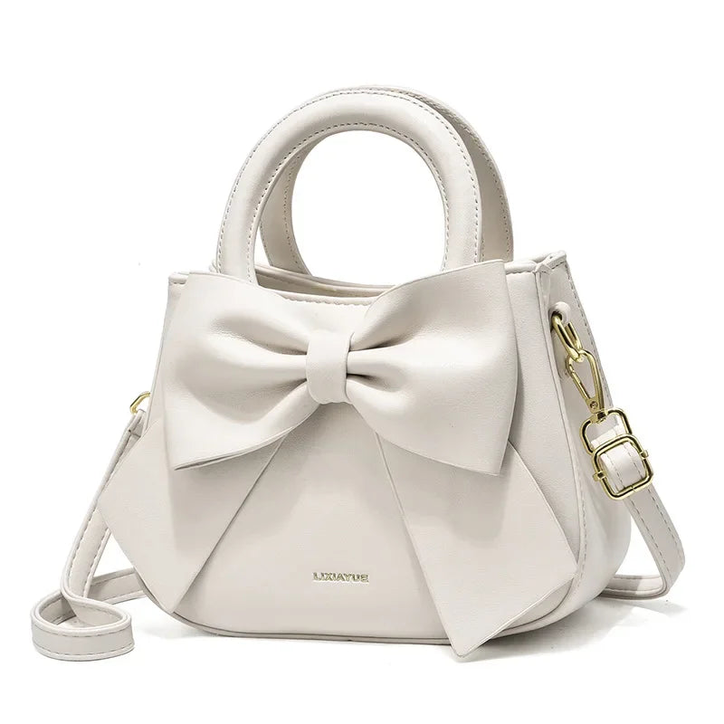 Fashion casual women's handbags with cute bows in black, white, blue, and khaki PU material, featuring trendy shoulder and underarm styles.