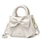 Fashion casual women's handbags with cute bows in black, white, blue, and khaki PU material, featuring trendy shoulder and underarm styles.