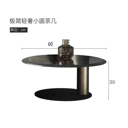 European luxury round coffee table by BackupMyFilesNow.com, with stainless steel frame and tempered glass top for modern living rooms.