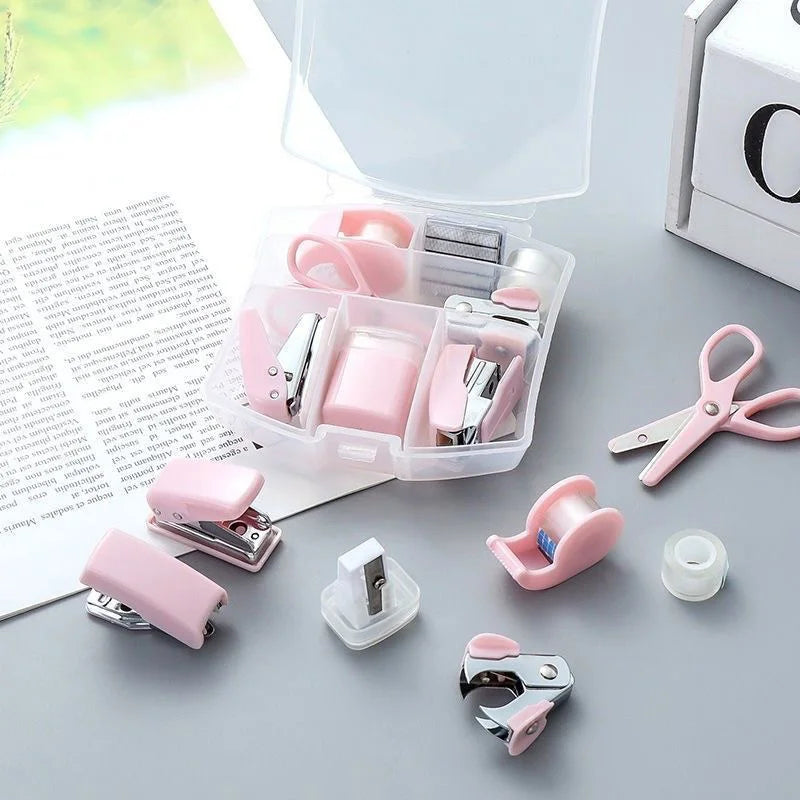 Pink 8-piece mini office supply kit with stapler, scissors, staple remover, tape dispenser, staples, and a scrapbook tool box.