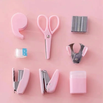Pink 8-piece mini office supply kit with stapler, scissors, staple remover, tape dispenser, staples, and scrapbook tools.