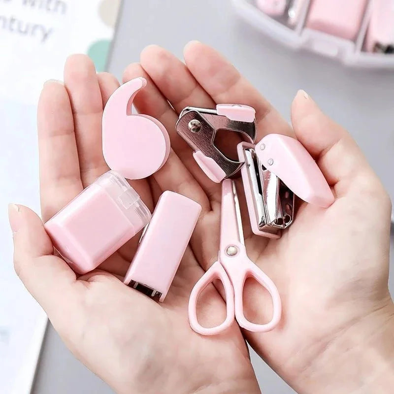 Pink 8-piece mini office supply kit including stapler, scissors, staple remover, tape dispenser, and scrapbook tools.