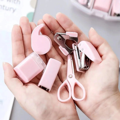 Pink 8-piece mini office supply kit including stapler, scissors, staple remover, tape dispenser, and scrapbook tools.