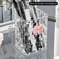 Desktop pen holder and storage box with a bow decoration and basket for organizing office supplies.