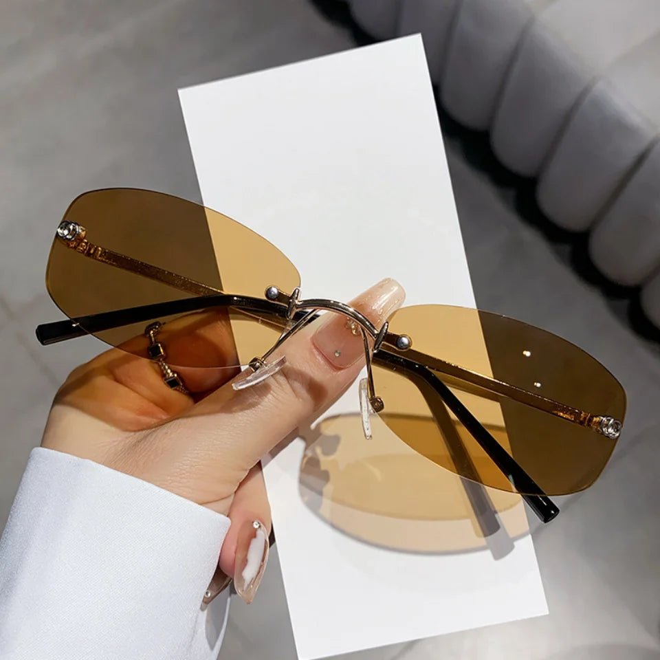 Luxury brand frameless sunglasses for women and men with UV400 protection, trendy design, suitable for travel, hiking, and driving.