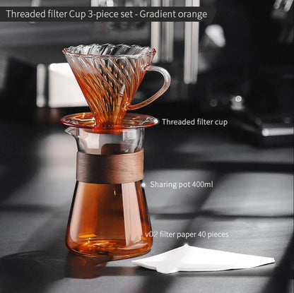 Amber gold hand-brewed coffee maker set with borosilicate glass dripper, sharing pot, and V02 coffee filter for fresh coffee brewing.
