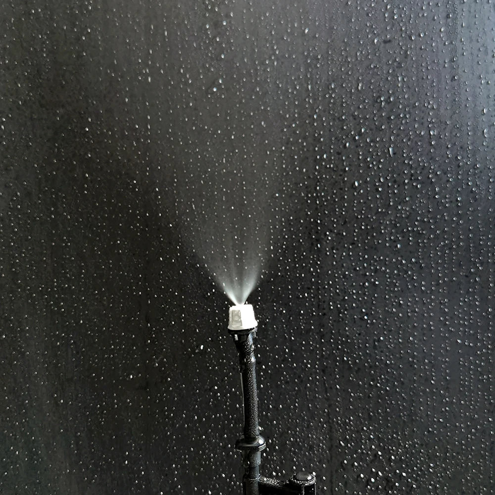 OAISI 20-pack plastic garden misting sprinkler heads with nozzles and tee joints for watering and irrigation systems.