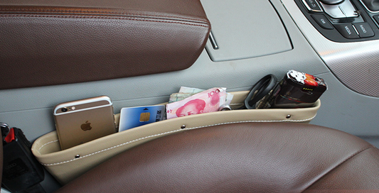 Beige car seat gap storage organizer with trash box from BACKUPMYFILESNOW.COM®, designed to keep essentials tidy and accessible.