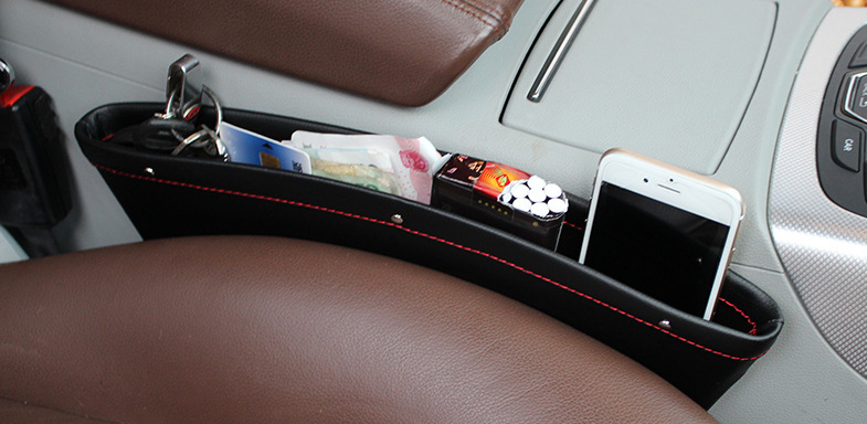 Beige car seat gap storage organizer and trash box by BACKUPMYFILESNOW.COM®, designed to keep essentials and trash tidy in vehicle.