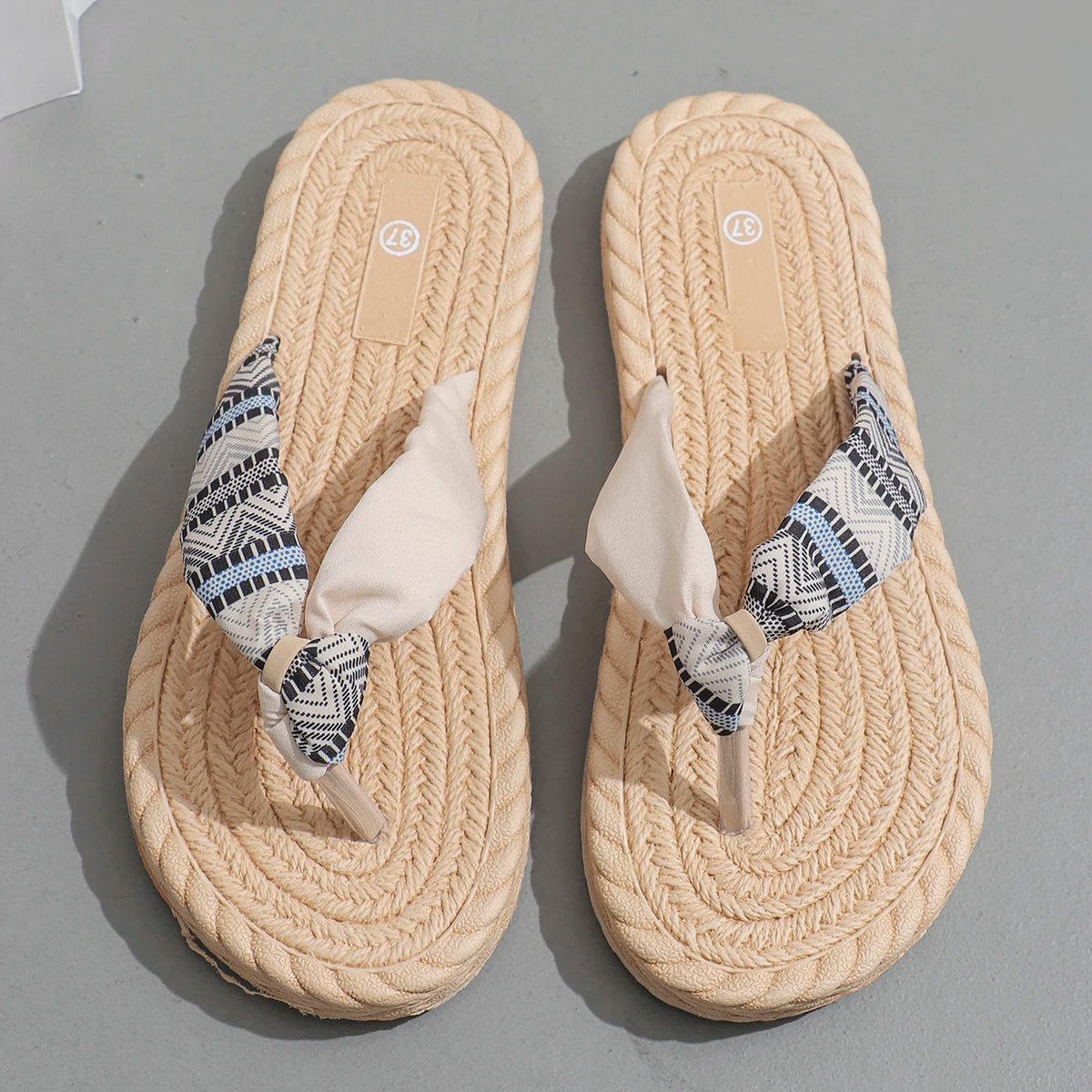 Beige women's flip-flops with ethnic graffiti design, soft sole, anti-slip, wear-resistant, and anti-linen features.