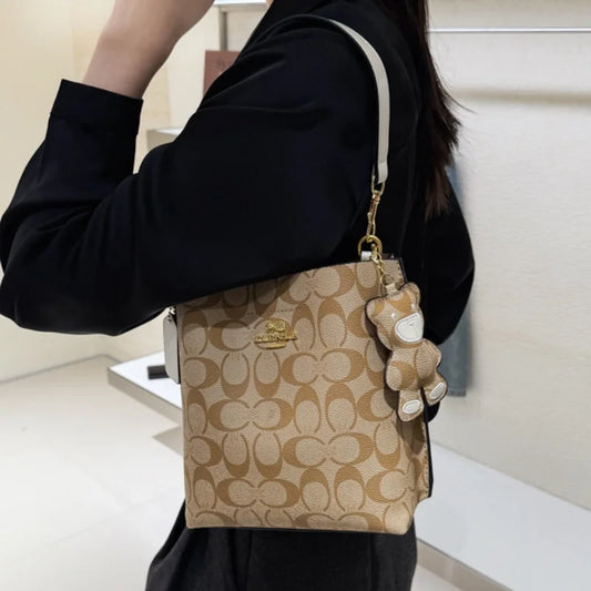 Elegant beige bucket handbag by BackupMyFilesNow.com, featuring a stylish design, versatile for all occasions, single shoulder style.