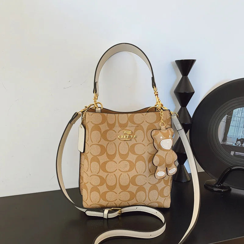 Elegant beige bucket handbag by BackupMyFilesNow.com, featuring a stylish, luxurious design perfect for versatile occasions.