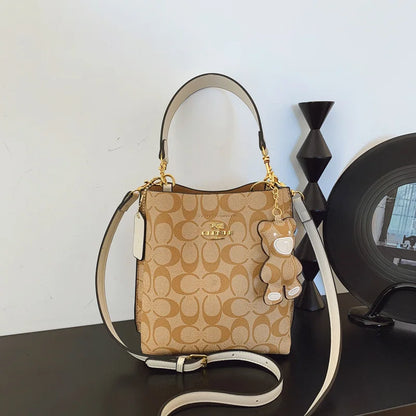 Elegant beige bucket handbag by BackupMyFilesNow.com, featuring a stylish, luxurious design perfect for versatile occasions.