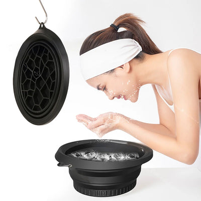 Large black foldable silicone bowl for face ice baths and skincare routines, portable and flexible for women and girls.