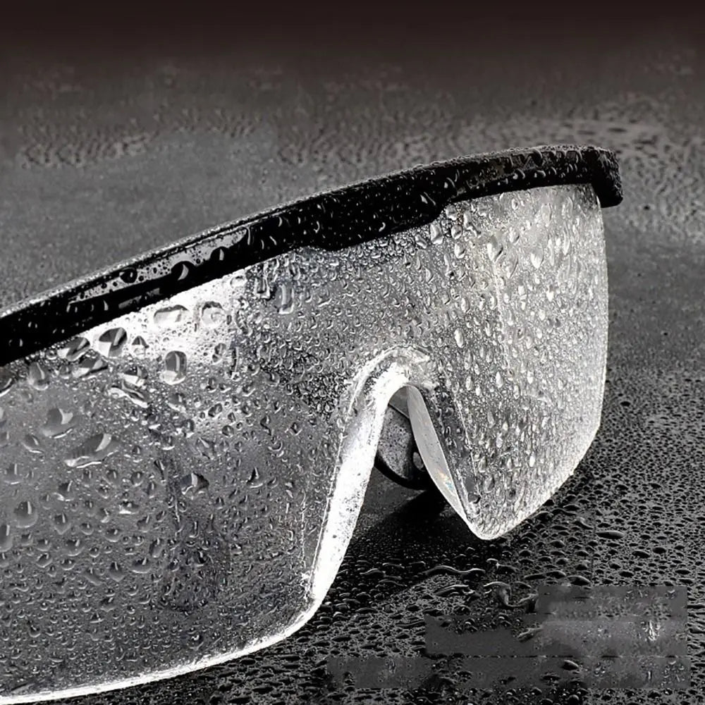 Black anti-splash safety goggles with anti-fog, windproof, dustproof, and waterproof design for work and cycling protection.