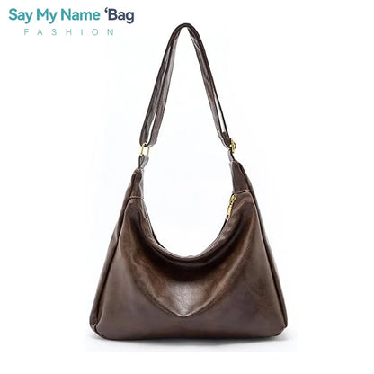 Black 2025 women's handbag with soft PU leather, foldable slouchy tote, crossbody strap, and zipper closure.
