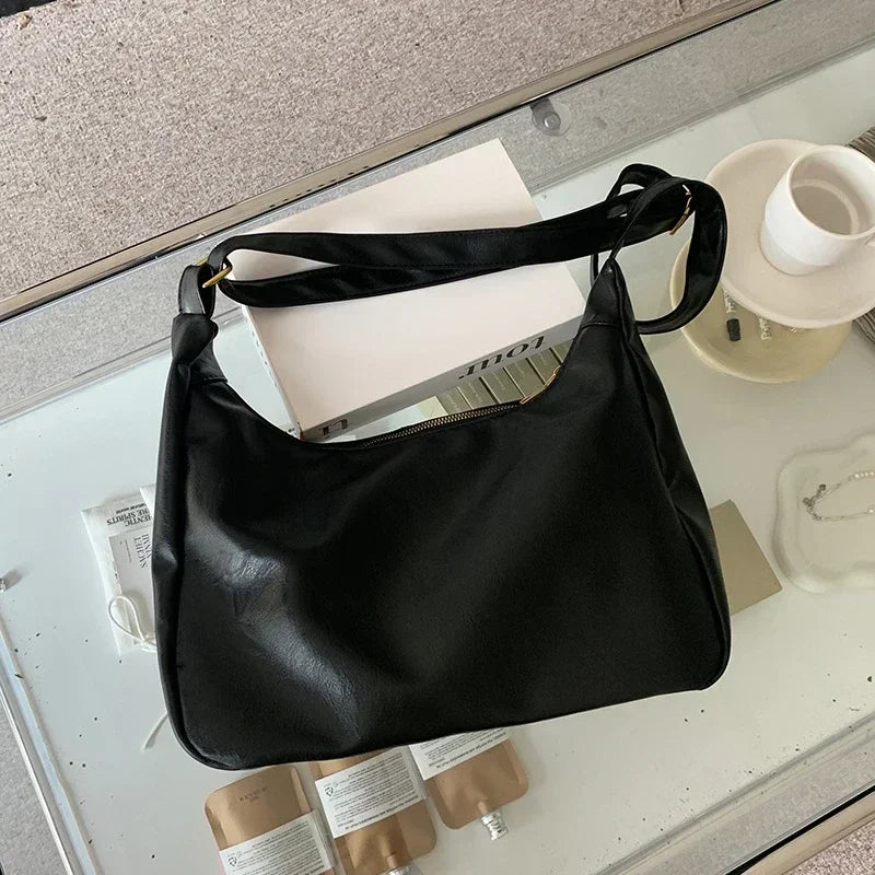 Black 2025 women’s handbag with soft PU leather, foldable slouchy tote, crossbody style, zipper closure, vintage design