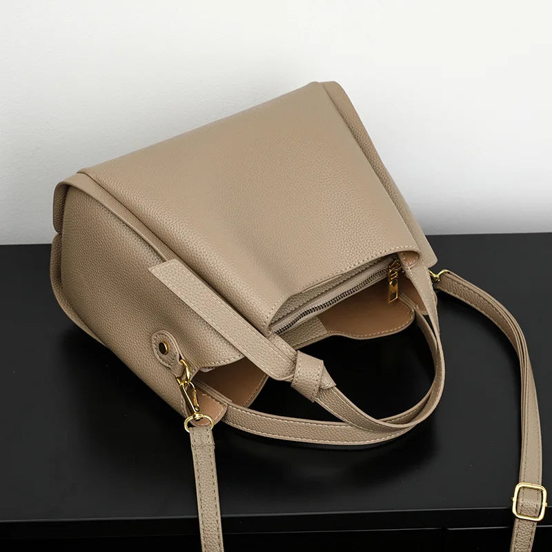Black women's shoulder bag with retro style, large capacity, simple texture, and portable messenger design.