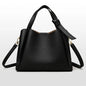 Black women's retro fashion shoulder handbag with simple texture, large capacity, and portable messenger bucket style.