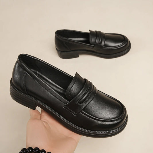 Black women's casual leather loafers featuring slip-on design, lightweight construction, and classic penny loafer style for comfortable walking.