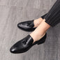 Black men's slip-on wedding loafers with tassels, leather formal dress shoes in British style for business or special occasions.
