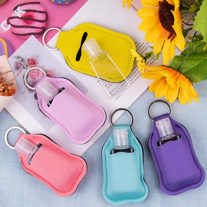 Set of 60 reusable clear hand sanitizer keychain holders and travel bottles for backpacks and purses.