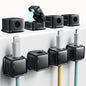 Black magnetic cord organizer holder 8-pack with adhesive clips for managing phone chargers, cables, and wires on desks or nightstands.