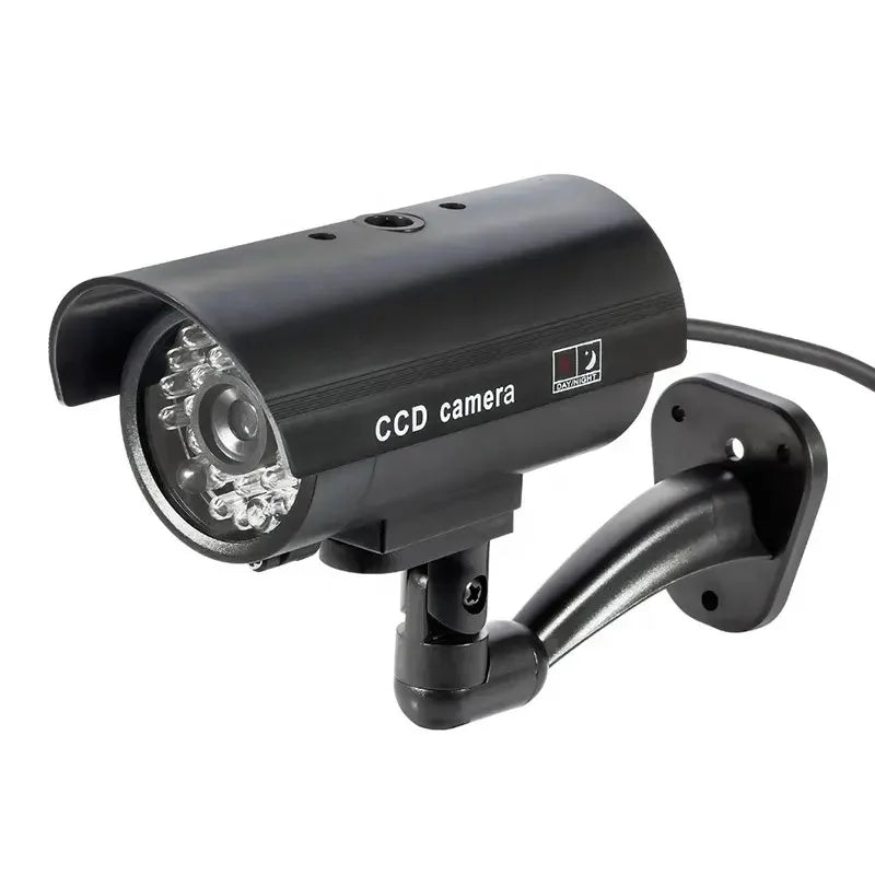 Black dummy security camera with red flashing LED light, battery-powered, suitable for indoor and outdoor use.