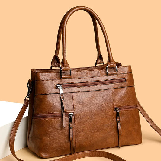 Elegant black women's handbag with top handle, shoulder strap, and tote style, made of high-quality PU leather.