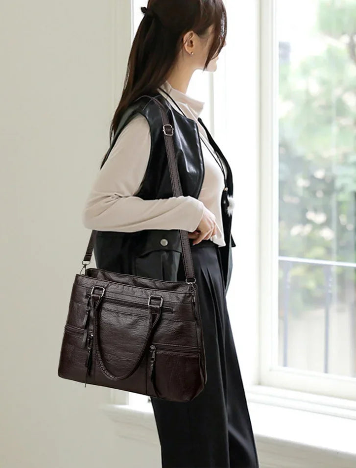 Elegant black women's handbag with top handle and shoulder strap, made of high-quality PU leather, versatile tote and crossbody style.