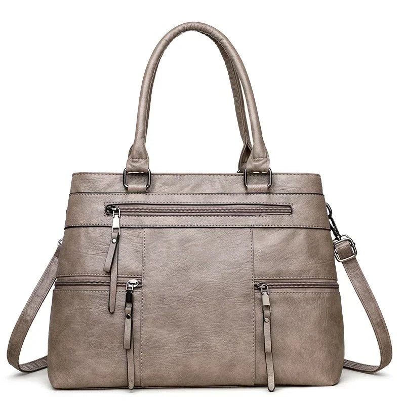 Black elegant women's handbag with top handle, shoulder strap, and spacious tote design made of high-quality PU leather.