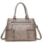 Black elegant women's handbag with top handle, shoulder strap, and spacious tote design made of high-quality PU leather.