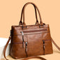 Black elegant women's handbag made of high-quality PU leather with top handle and shoulder strap, casual tote style.