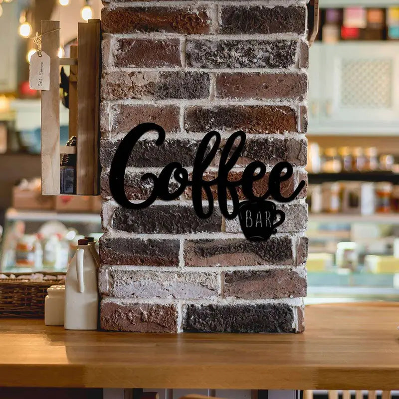 Black metal hanging coffee wall sign featuring a coffee cup design, ideal for coffee shop or kitchen decor.