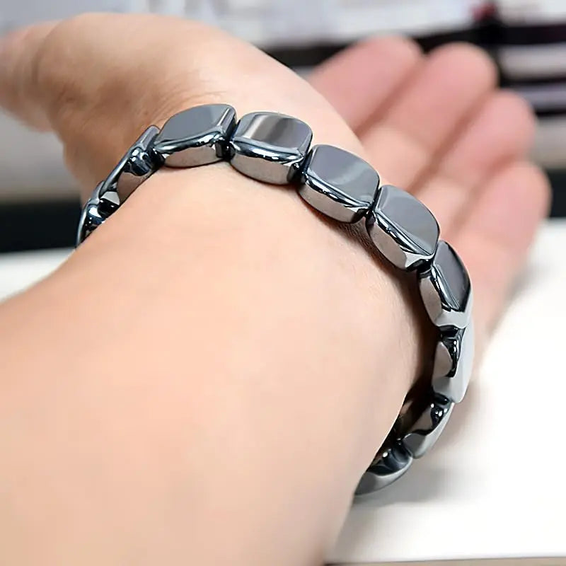 Black hematite bracelet for men featuring beaded stretch design, natural hematite stones, emphasizing confidence and healing jewelry.