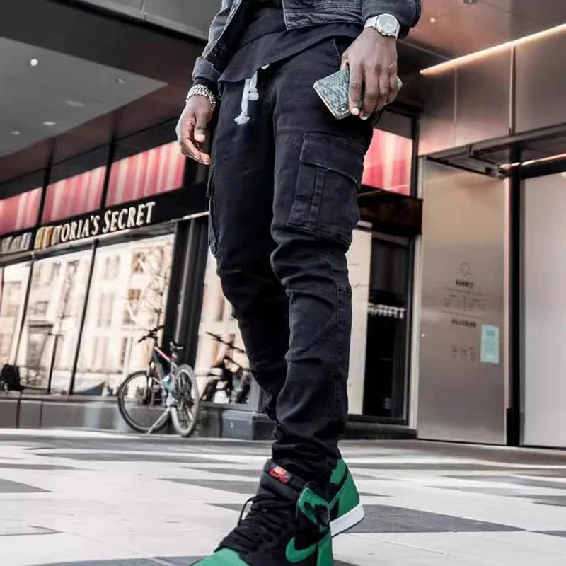 Men's black elastic denim cargo jeans with multi pockets, slim fit, casual style, mid waist, suitable for daily wear.