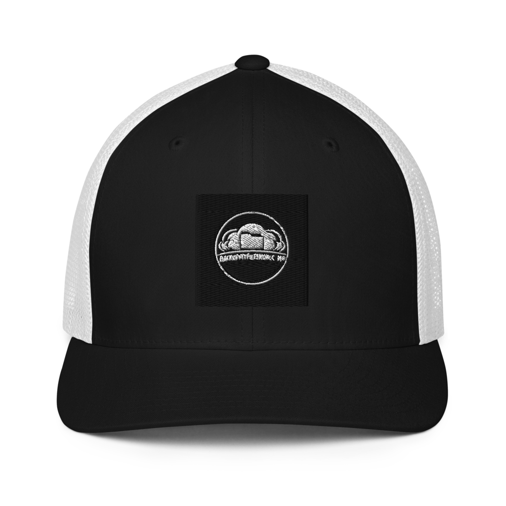 Black Flexfit 6511 closed-back trucker cap with mesh back and adjustable strap, stylish and breathable headwear.