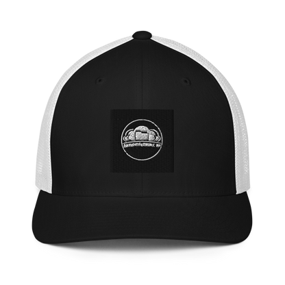 Black Flexfit 6511 closed-back trucker cap with mesh back and adjustable strap, stylish and breathable headwear.